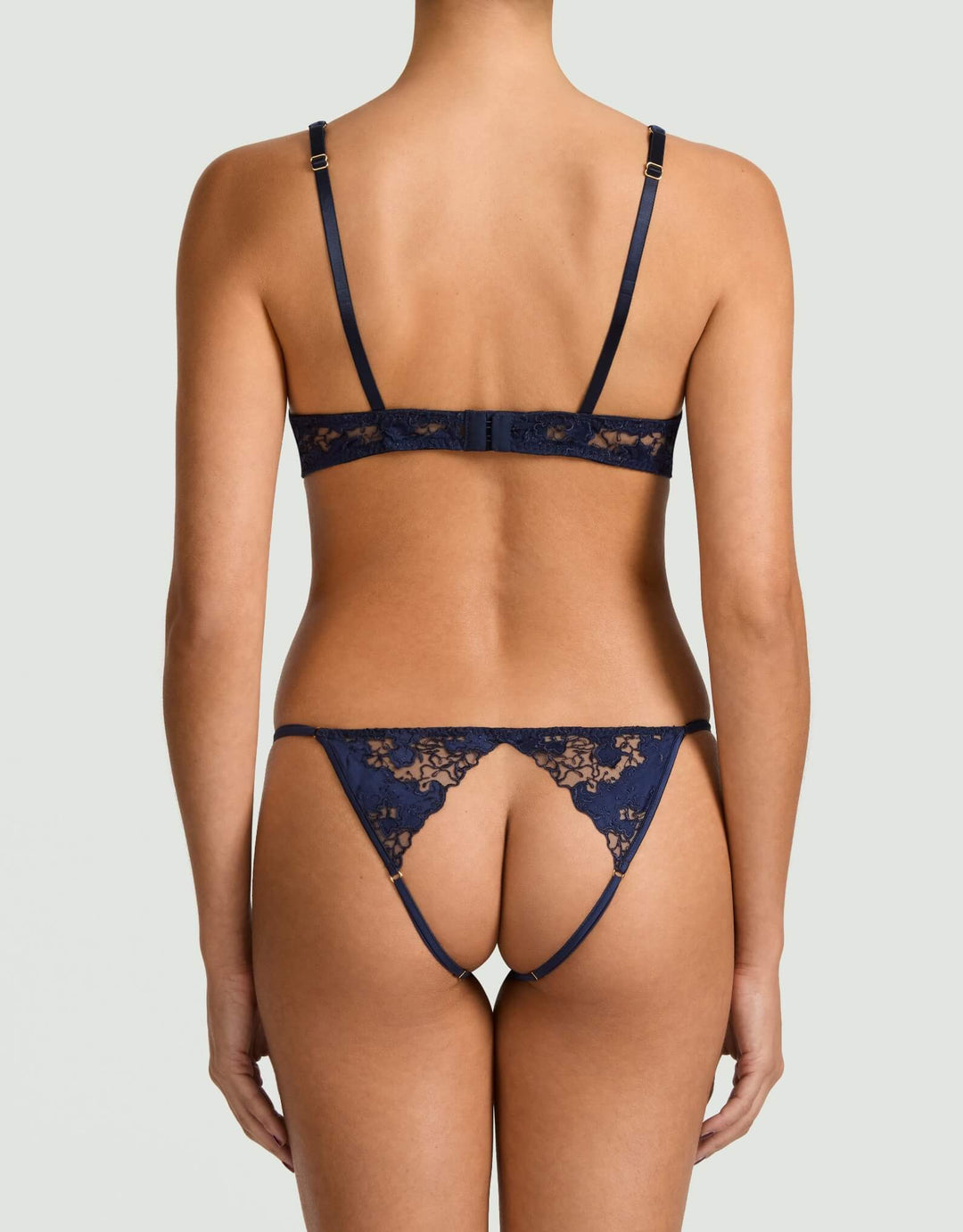 Coco de Mer Arella Wired Open Playsuit in black silk with embroidered open cups, golden ring detail, and open back.