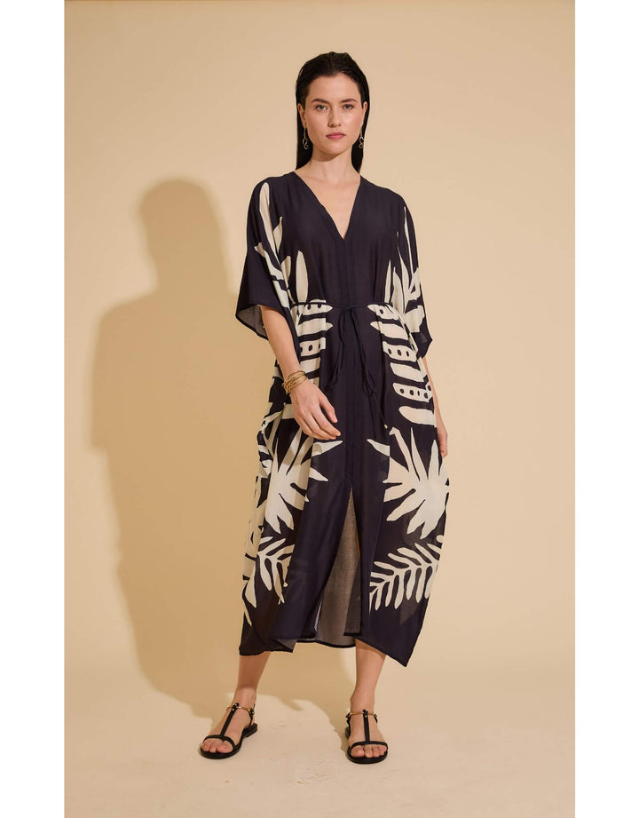 Lenny Niemeyer Frame Kaftan Dress in Jungle with tropical foliage print, V-neckline, loose sleeves, long length, styled over black swimwear.