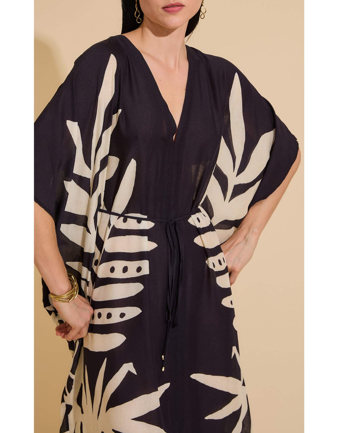Lenny Niemeyer Frame Kaftan Dress in Jungle with tropical foliage print, V-neckline, loose sleeves, long length, styled over black swimwear.