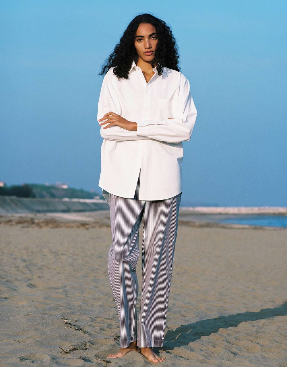 Lido oversized cotton poplin shirt in Chalk white with rounded hem and pearl buttons