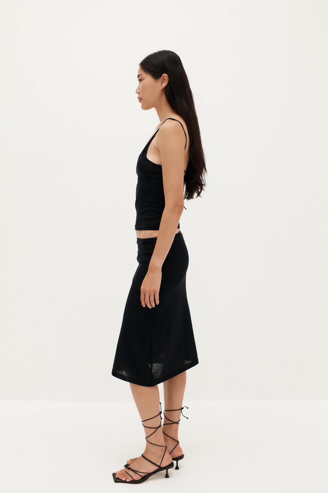 Side View of Ziah Sheer Knit Low-Rise Skirt in Black - Sheer Design with Organic Cotton