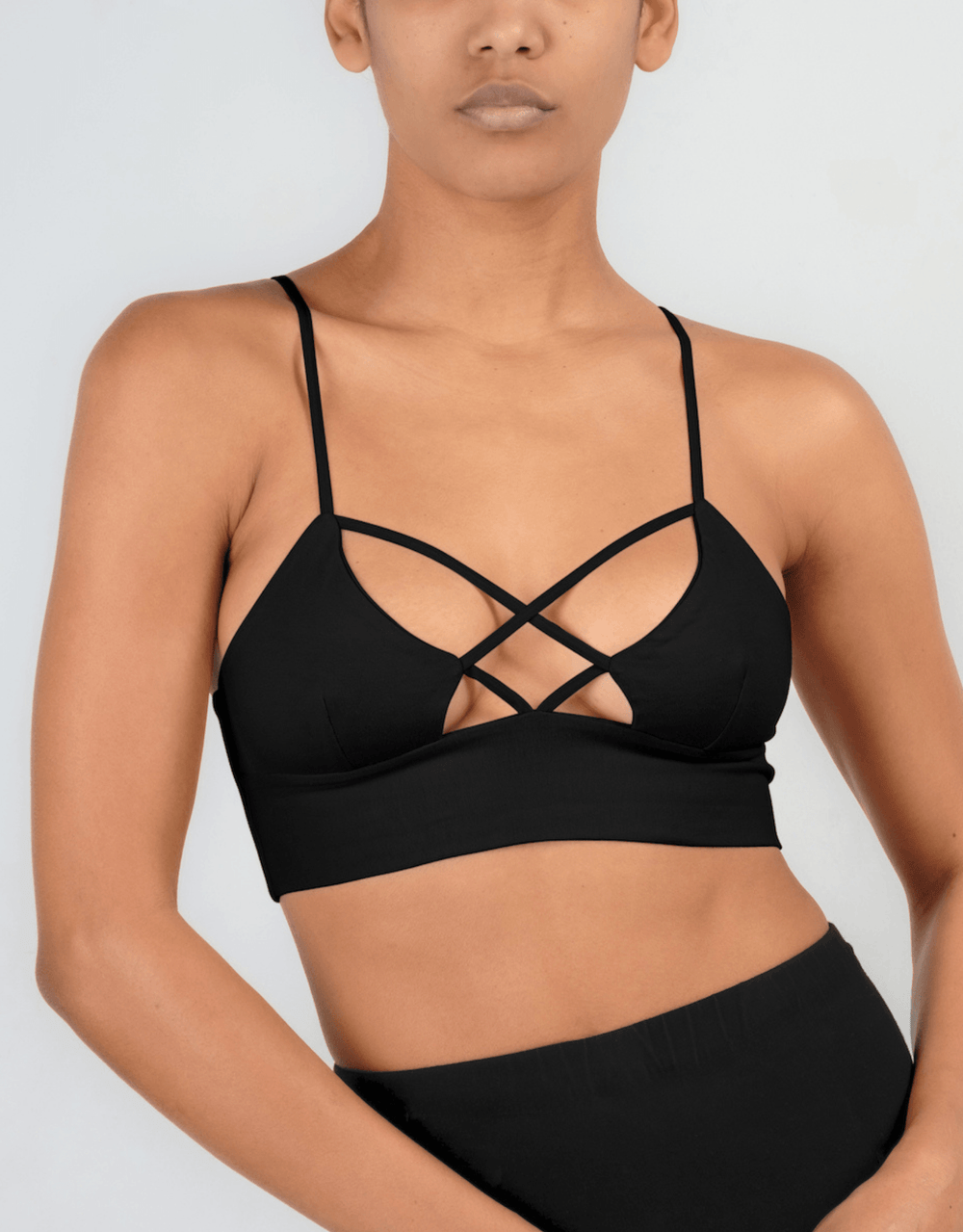 Essentials for Zula Olympia Bralette Black — studio front view showing crossover straps