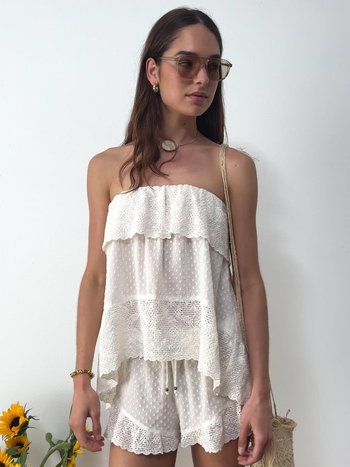 Boteh Serenia white Strapless Frill Top and short  — model close-up with sunglasses