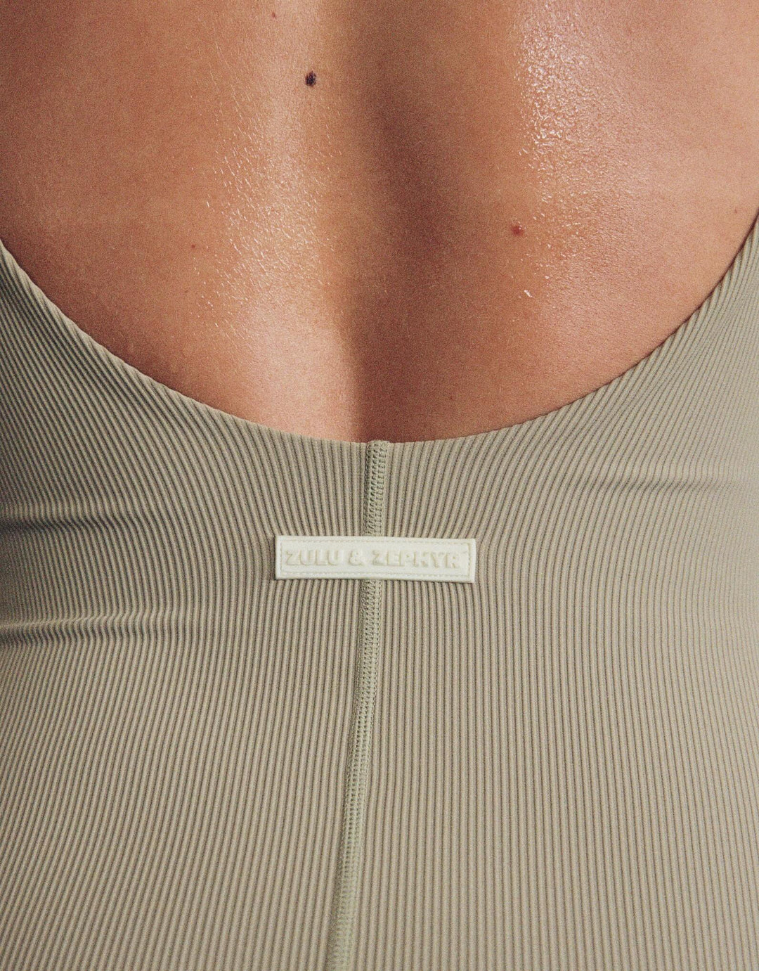 Model wearing Zulu and Zephyr Stripe Rib Bodysuit in Olive